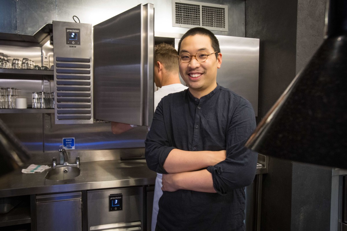 Shing Tat Chung In Front Of Precision Wall Cabinets In The BAO Kitchen 